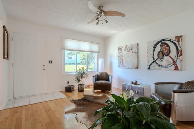 712 Fremont St, Bloomington, IL 61701 - living room featuring a ceiling fan, hardwood / wood-style floors, and a textured ceiling