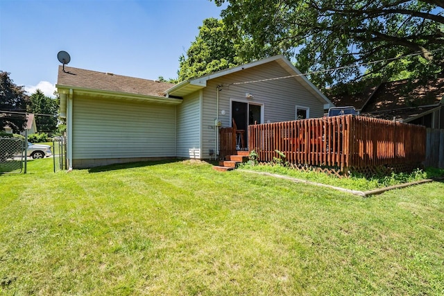 712 Fremont St, Bloomington, IL 61701 - rear view of house with a deck and a shingled roof