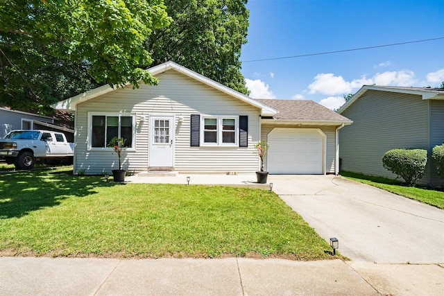 712 Fremont St, Bloomington, IL 61701 - view of front facade with a garage, concrete driveway, and a front lawn