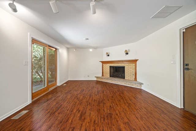 808 S Cedarcrest Dr, Schaumburg, IL 60193 - unfurnished living room featuring wood finished floors, a brick fireplace, and track lighting