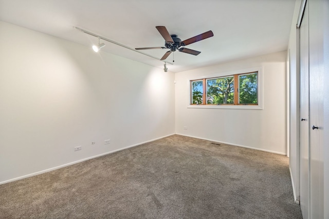 808 S Cedarcrest Dr, Schaumburg, IL 60193 - carpeted empty room with track lighting and ceiling fan