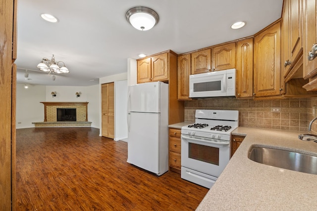 808 S Cedarcrest Dr, Schaumburg, IL 60193 - kitchen featuring white appliances, light countertops, decorative backsplash, a chandelier, and open floor plan