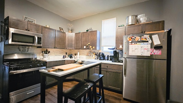 7250 S Morgan St, Chicago, IL 60621 - kitchen with appliances with stainless steel finishes, dark wood-style flooring, tasteful backsplash, light countertops, and dark brown cabinetry