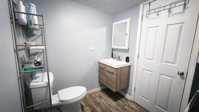 7250 S Morgan St, Chicago, IL 60621 - half bathroom featuring vanity and wood finished floors
