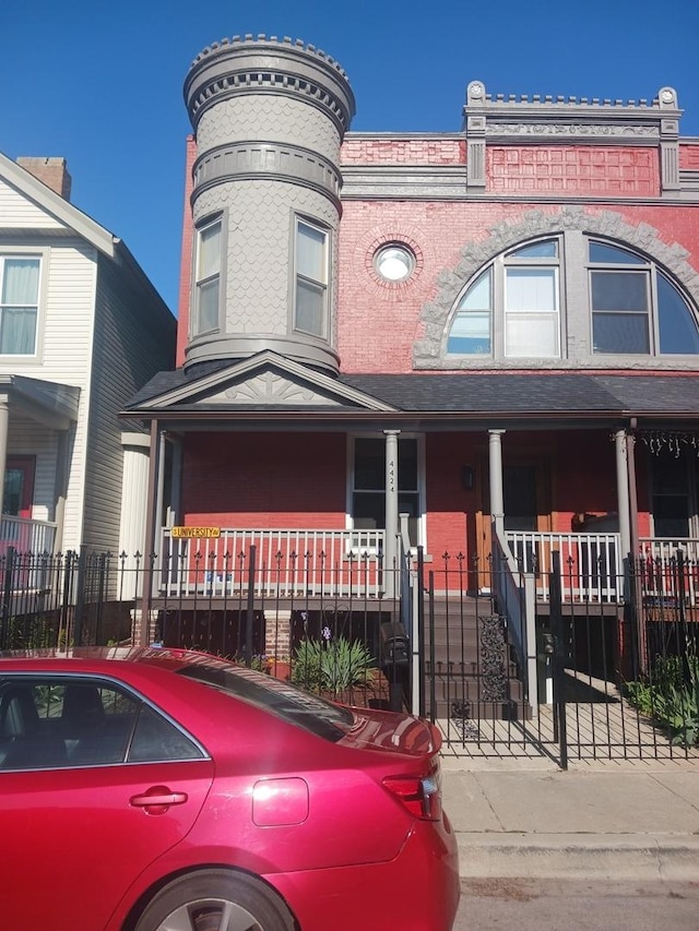 4424 S University Ave, Chicago, IL 60653 - view of front of property featuring covered porch, a fenced front yard, and a gate