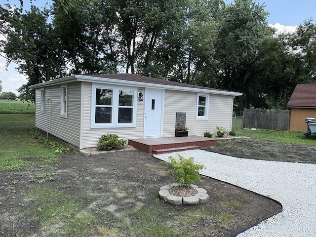 5101 W 1000 N Rd, Kankakee, IL 60901 - manufactured / mobile home with a wooden deck, a fire pit, and an outdoor structure