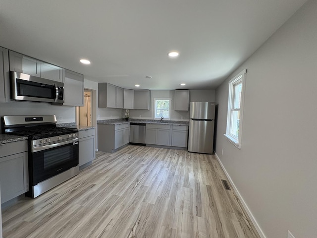 5101 W 1000 N Rd, Kankakee, IL 60901 - kitchen with stainless steel appliances, gray cabinetry, light wood-style floors, recessed lighting, and light stone countertops