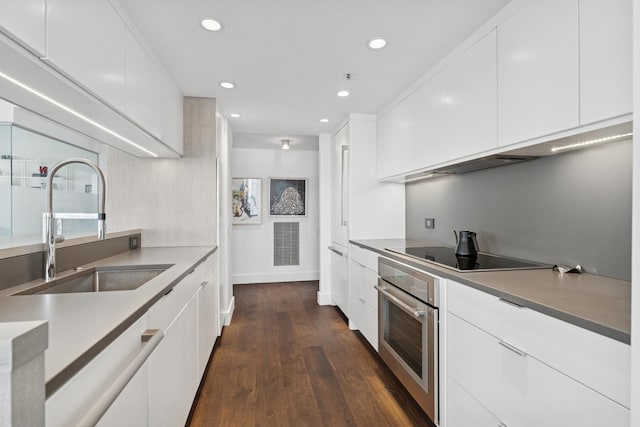 161 E Chicago Ave Unit 31F, Chicago, IL 60611 - kitchen featuring oven, modern cabinets, white cabinets, and recessed lighting