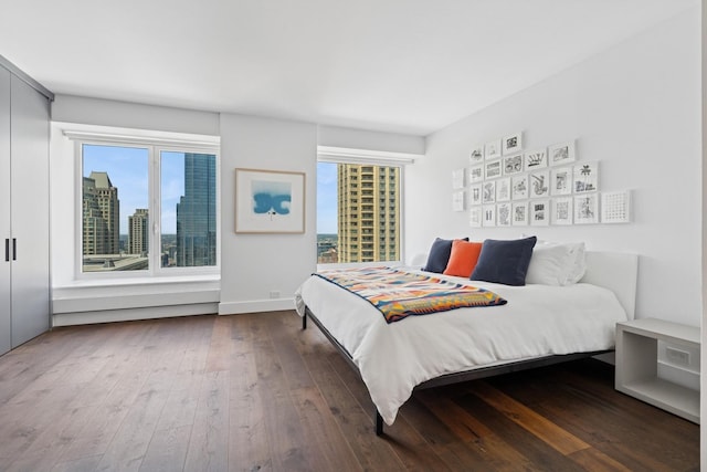 161 E Chicago Ave Unit 31F, Chicago, IL 60611 - bedroom with dark wood-style floors and a view of city
