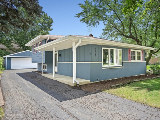 5895 Virginia Ave, Clarendon Hills, IL 60514 - view of front of home featuring an outbuilding, brick siding, board and batten siding, and a garage