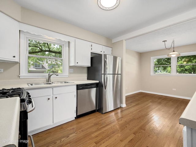 5895 Virginia Ave, Clarendon Hills, IL 60514 - kitchen featuring stainless steel appliances, white cabinets, light countertops, light wood-type flooring, and pendant lighting