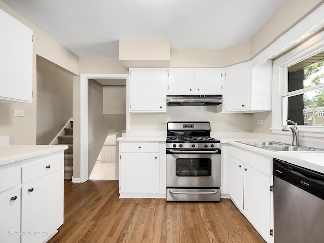 5895 Virginia Ave, Clarendon Hills, IL 60514 - kitchen featuring stainless steel appliances, under cabinet range hood, light countertops, white cabinets, and light wood finished floors
