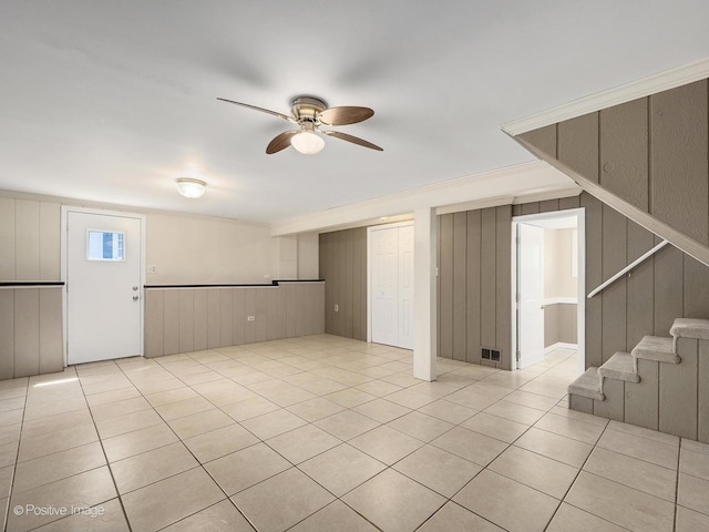 5895 Virginia Ave, Clarendon Hills, IL 60514 - below grade area featuring ceiling fan, light tile patterned floors, a decorative wall, stairs, and wooden walls