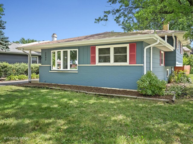 5895 Virginia Ave, Clarendon Hills, IL 60514 - view of side of home with a chimney, a yard, and brick siding