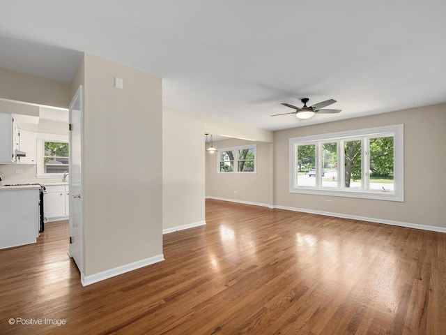 5895 Virginia Ave, Clarendon Hills, IL 60514 - unfurnished living room with ceiling fan, wood finished floors, and plenty of natural light