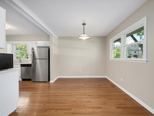 5895 Virginia Ave, Clarendon Hills, IL 60514 - unfurnished dining area featuring light wood-type flooring and baseboards