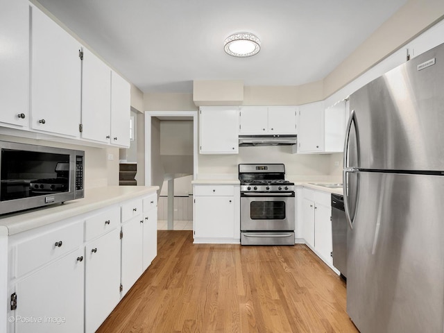 5895 Virginia Ave, Clarendon Hills, IL 60514 - kitchen featuring appliances with stainless steel finishes, light countertops, light wood-style floors, white cabinetry, and under cabinet range hood