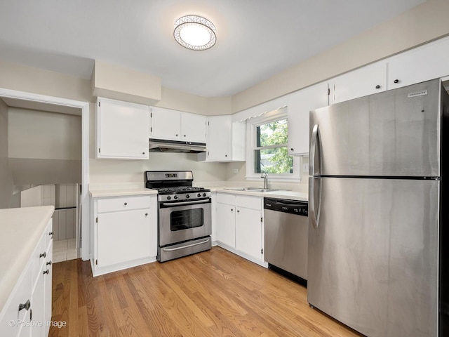5895 Virginia Ave, Clarendon Hills, IL 60514 - kitchen with stainless steel appliances, under cabinet range hood, light wood-type flooring, light countertops, and white cabinetry