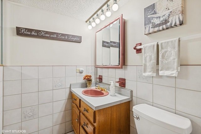 5204 Midlothian Unit 214, Crestwood, IL 60418 - half bathroom with vanity, a textured ceiling, tile walls, and a wainscoted wall