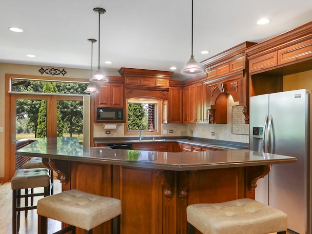 9804 Palmer Dr, Lakewood, IL 60014 - kitchen with stainless steel appliances, dark countertops, backsplash, recessed lighting, and decorative light fixtures