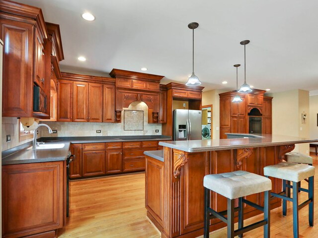9804 Palmer Dr, Lakewood, IL 60014 - kitchen featuring stainless steel fridge, light wood-type flooring, tasteful backsplash, dark countertops, and recessed lighting
