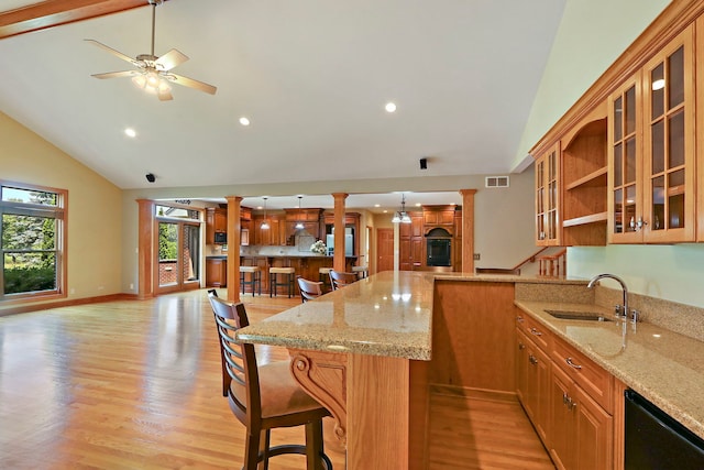 9804 Palmer Dr, Lakewood, IL 60014 - kitchen with ornate columns, a breakfast bar area, recessed lighting, high vaulted ceiling, and light wood-style floors