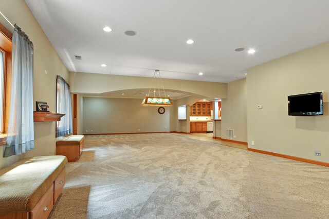 9804 Palmer Dr, Lakewood, IL 60014 - unfurnished living room featuring light colored carpet, arched walkways, and recessed lighting