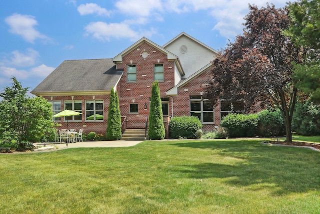 9804 Palmer Dr, Lakewood, IL 60014 - view of front of house featuring brick siding, a front yard, and a patio area