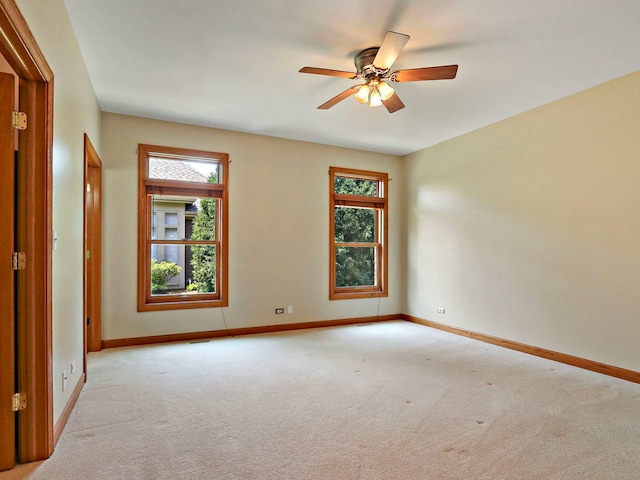 9804 Palmer Dr, Lakewood, IL 60014 - empty room featuring healthy amount of natural light, light colored carpet, and a ceiling fan