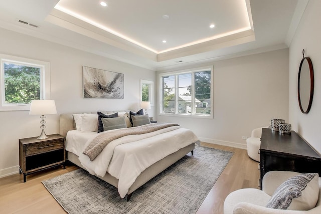1437 Ashland Ave, River Forest, IL 60305 - bedroom featuring multiple windows, a raised ceiling, light wood-style floors, and recessed lighting