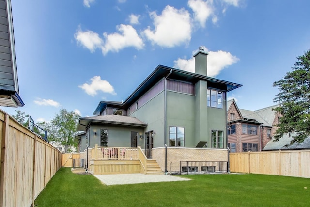 1437 Ashland Ave, River Forest, IL 60305 - back of property featuring a fenced backyard, a chimney, stucco siding, a wooden deck, and stairway