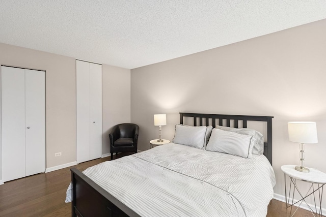 30 E Huron St Unit 2108, Chicago, IL 60611 - bedroom featuring dark wood-style floors, multiple closets, and a textured ceiling