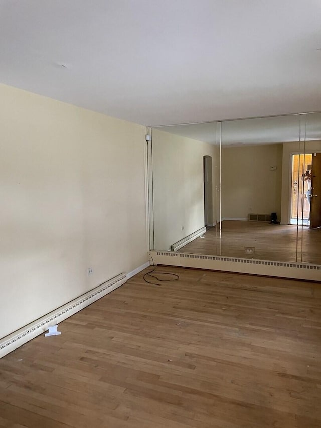 2020 W 53rd Pl, Chicago, IL 60609 - empty room with wood finished floors and baseboard heating