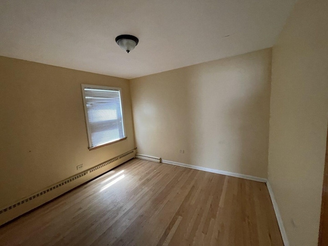 2020 W 53rd Pl, Chicago, IL 60609 - unfurnished room featuring a baseboard heating unit and light wood-style flooring