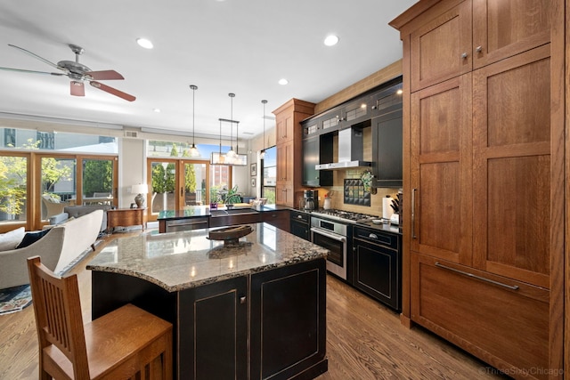 849 W Monroe St Unit Ph5, Chicago, IL 60607 - kitchen with wall chimney exhaust hood, a peninsula, a ceiling fan, dark wood-style flooring, and recessed lighting