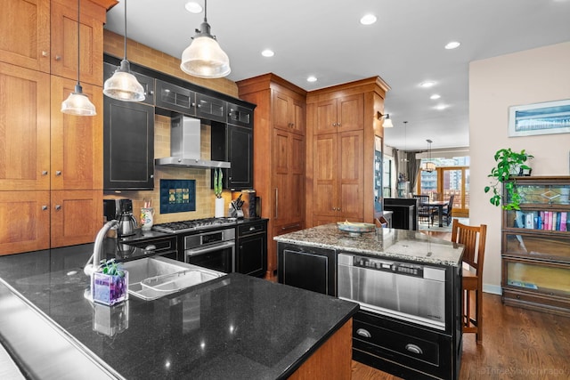 849 W Monroe St Unit Ph5, Chicago, IL 60607 - kitchen with wall chimney range hood, a warming drawer, dark wood-type flooring, recessed lighting, and dark stone countertops