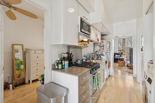 1532 N Greenview Ave, Chicago, IL 60642 - kitchen featuring appliances with stainless steel finishes, light wood finished floors, white cabinetry, a ceiling fan, and light stone counters