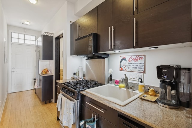 1532 N Greenview Ave, Chicago, IL 60642 - kitchen with black microwave, gas range, light wood-type flooring, and dark brown cabinetry