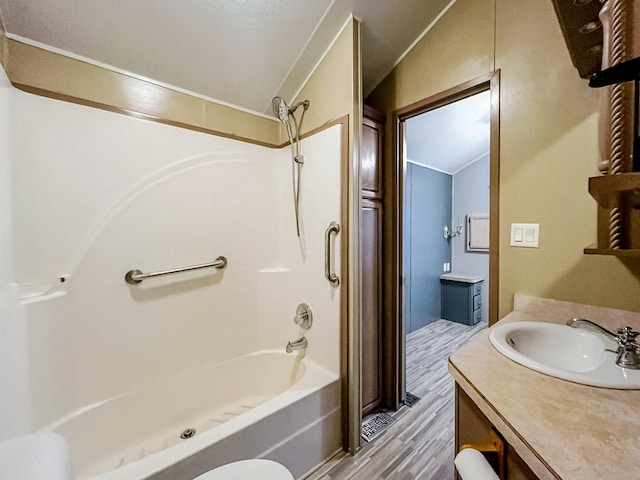 59 Fossil Ridge Ct, Wilmington, IL 60481 - bathroom featuring wood finished floors, vanity, shower / tub combination, and lofted ceiling