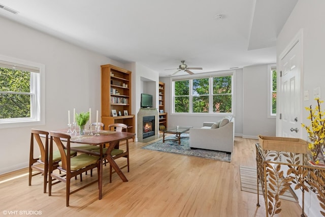 1931 N Campbell Ave Unit 2S, Chicago, IL 60647 - dining room with a glass covered fireplace, a ceiling fan, light wood-style flooring, and built in shelves