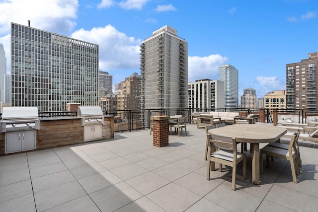 1255 N State Pkwy Unit 3D, Chicago, IL 60610 - view of patio with an outdoor kitchen, a view of skyline, outdoor dining space, and an outdoor living space