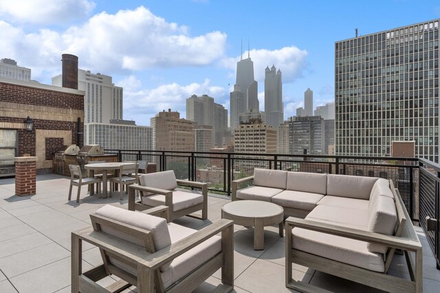 1255 N State Pkwy Unit 3D, Chicago, IL 60610 - view of patio featuring outdoor lounge area, a skyline view, and exterior kitchen