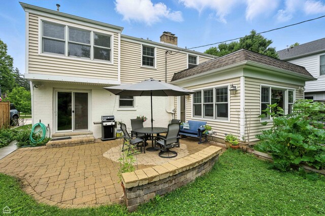 2907 Orchard Ave, Wilmette, IL 60091 - rear view of house with a patio, a chimney, a shingled roof, a yard, and brick siding