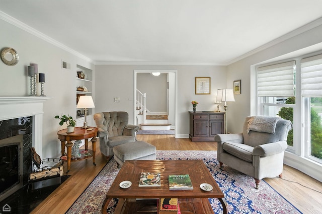 2907 Orchard Ave, Wilmette, IL 60091 - living area with light wood-style floors, stairs, crown molding, a high end fireplace, and built in shelves