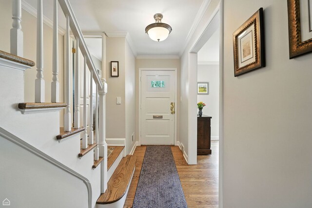 2907 Orchard Ave, Wilmette, IL 60091 - entryway with light wood-style floors, stairs, and crown molding