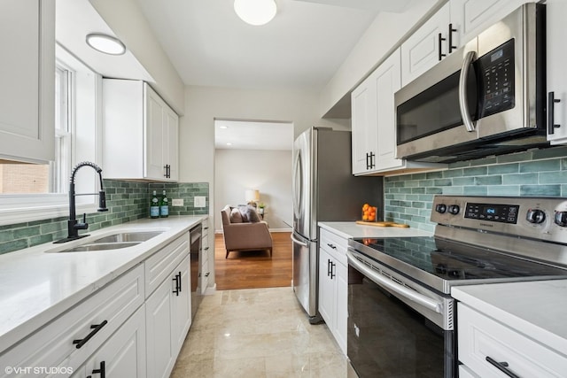 840 Forest Ave Unit C, Evanston, IL 60202 - kitchen featuring stainless steel appliances, light countertops, white cabinets, and decorative backsplash