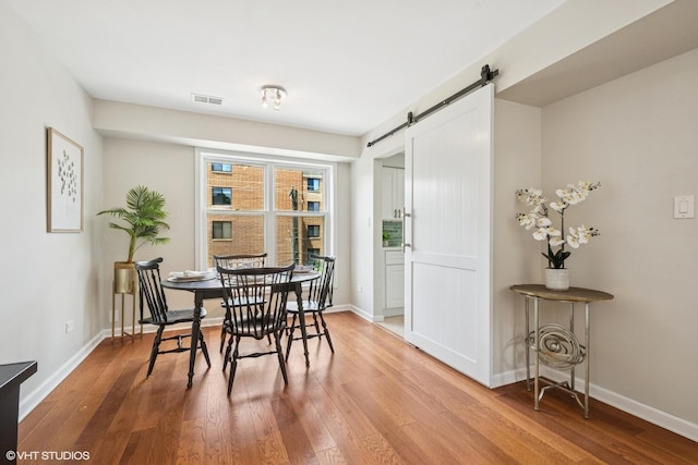 840 Forest Ave Unit C, Evanston, IL 60202 - dining room featuring a barn door and wood finished floors
