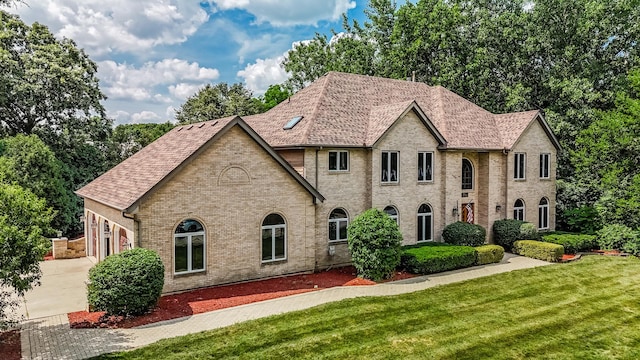 771 E Hickory Ave, Addison, IL 60101 - view of front of house with brick siding, a front lawn, concrete driveway, a garage, and a shingled roof