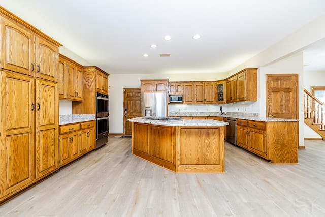 771 E Hickory Ave, Addison, IL 60101 - kitchen featuring stainless steel appliances, brown cabinets, a kitchen island, light wood finished floors, and recessed lighting