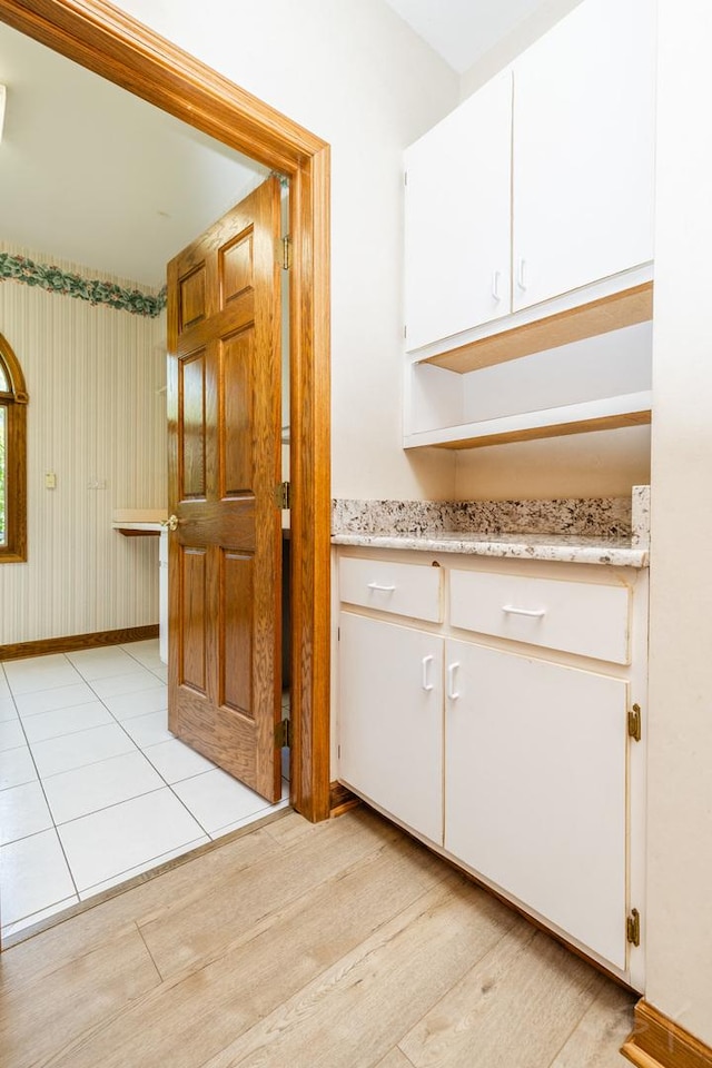771 E Hickory Ave, Addison, IL 60101 - kitchen featuring white cabinetry, light stone countertops, and light wood-style flooring